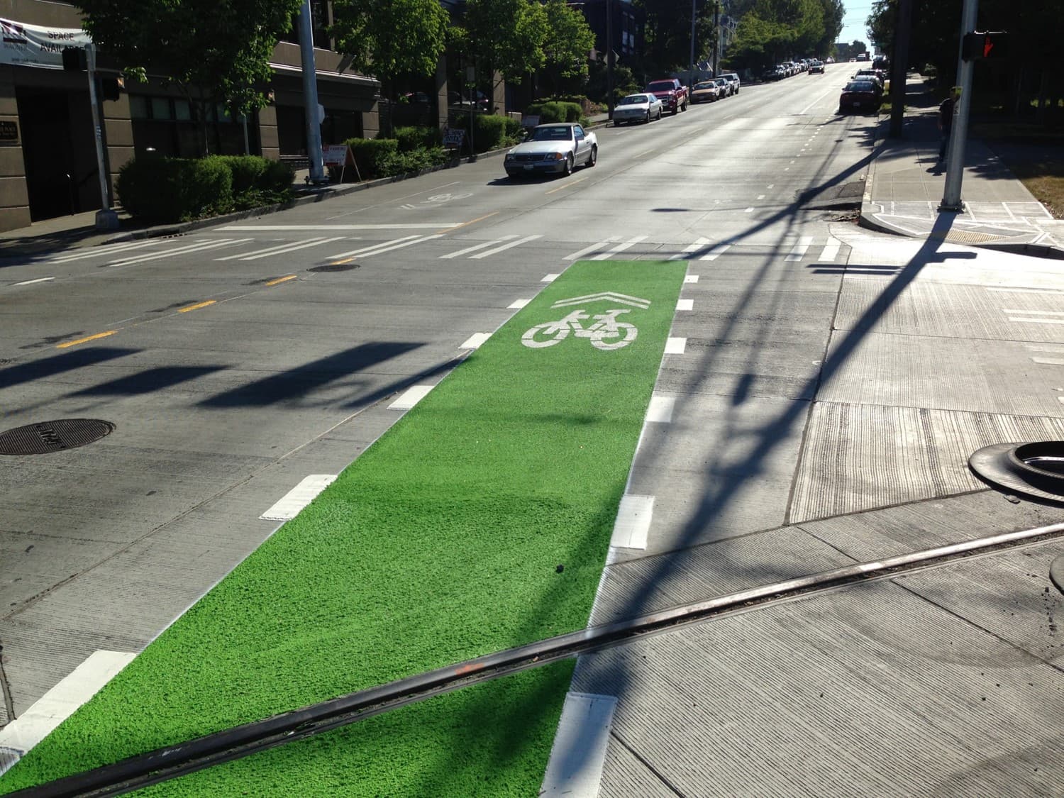 Coloured bike lane at a protected cycle track in Canada — installed by HUB Surface Systems