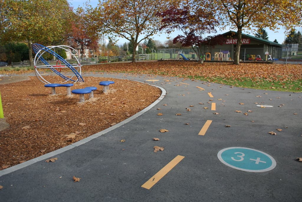 Park pathway coloured surface treatment — StreetBond slip-resistant recreational trail marking for Canadian municipal greenway