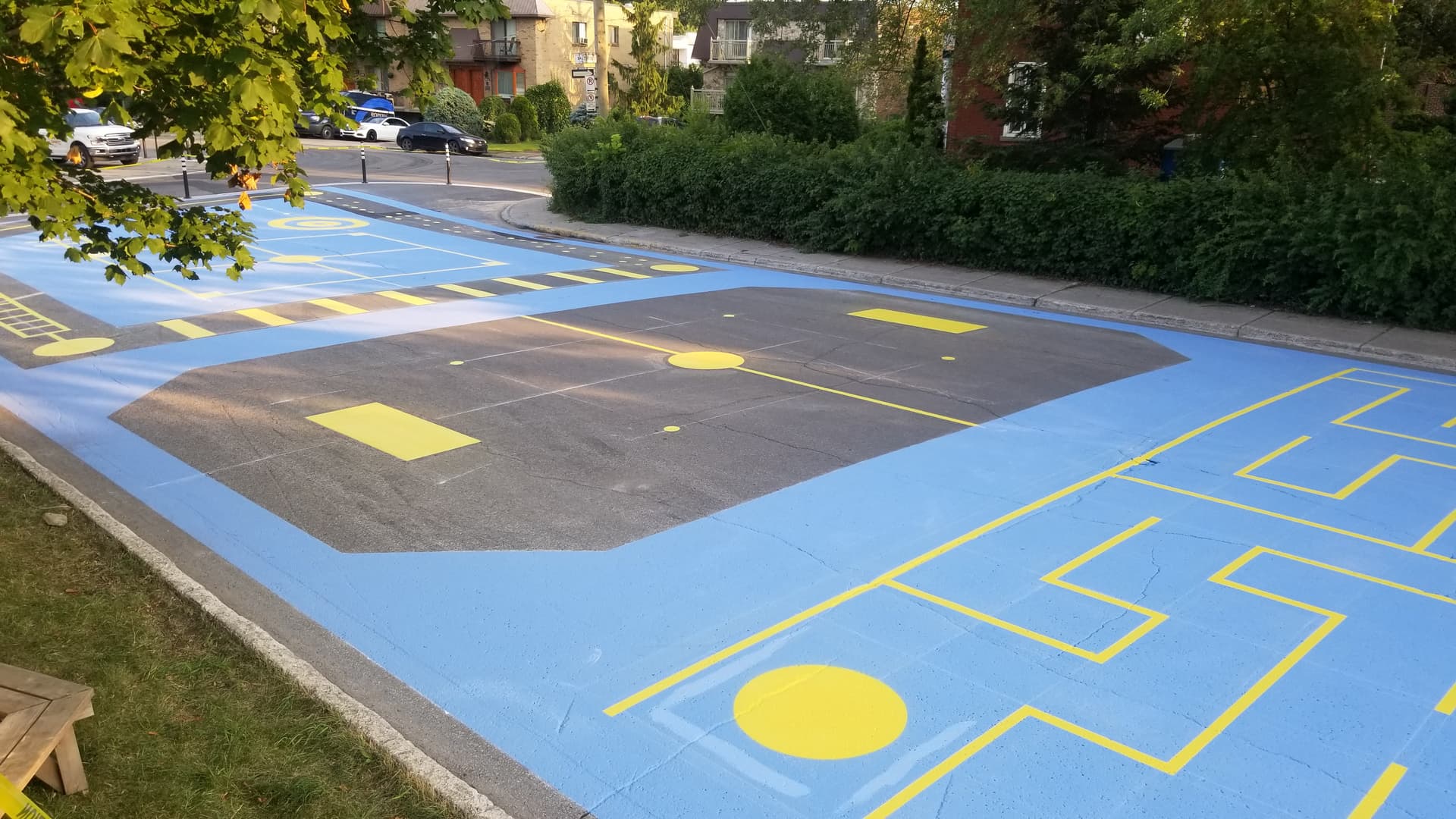 Playground surface graphics in coloured pavement coating and preformed play graphics — a park play zone, Canada