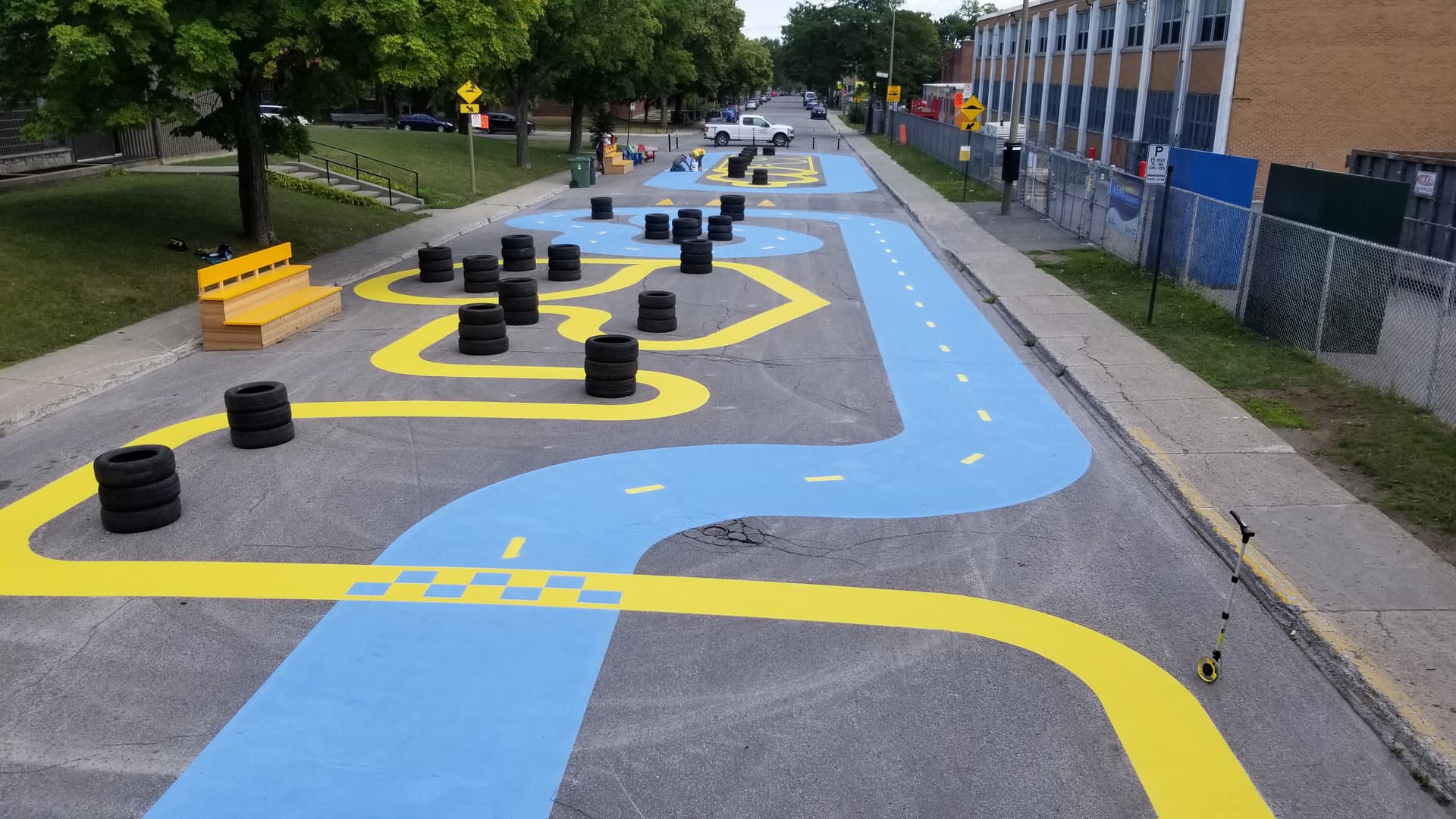 Playground surface graphics in coloured pavement coating and preformed play graphics — a daycare courtyard, Canada