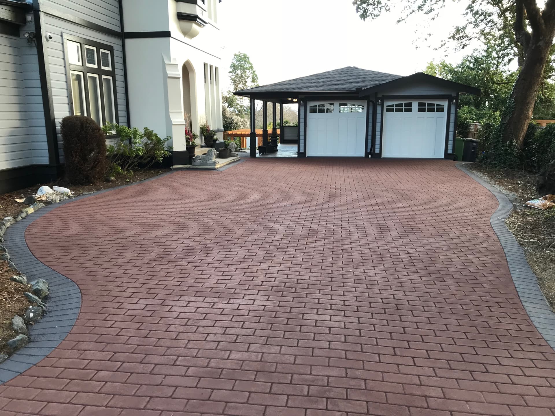 HUB Surface Systems stamped asphalt driveway — driveway surfacing with a paver appearance at a suburban home