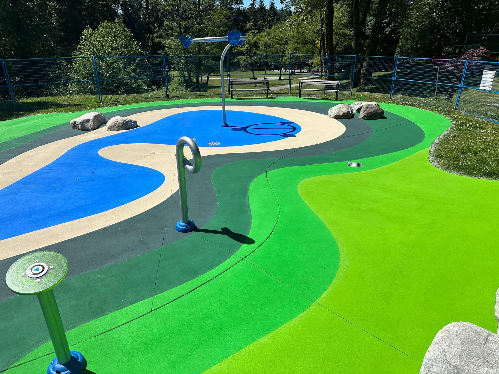 Splash pad surfacing in slip-resistant coloured surface coating — a park spray pad, Canada