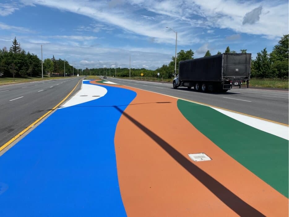 Traffic calming coloured pavement treatment — StreetBond and MMAX speed table surface markings for pedestrian safety zone