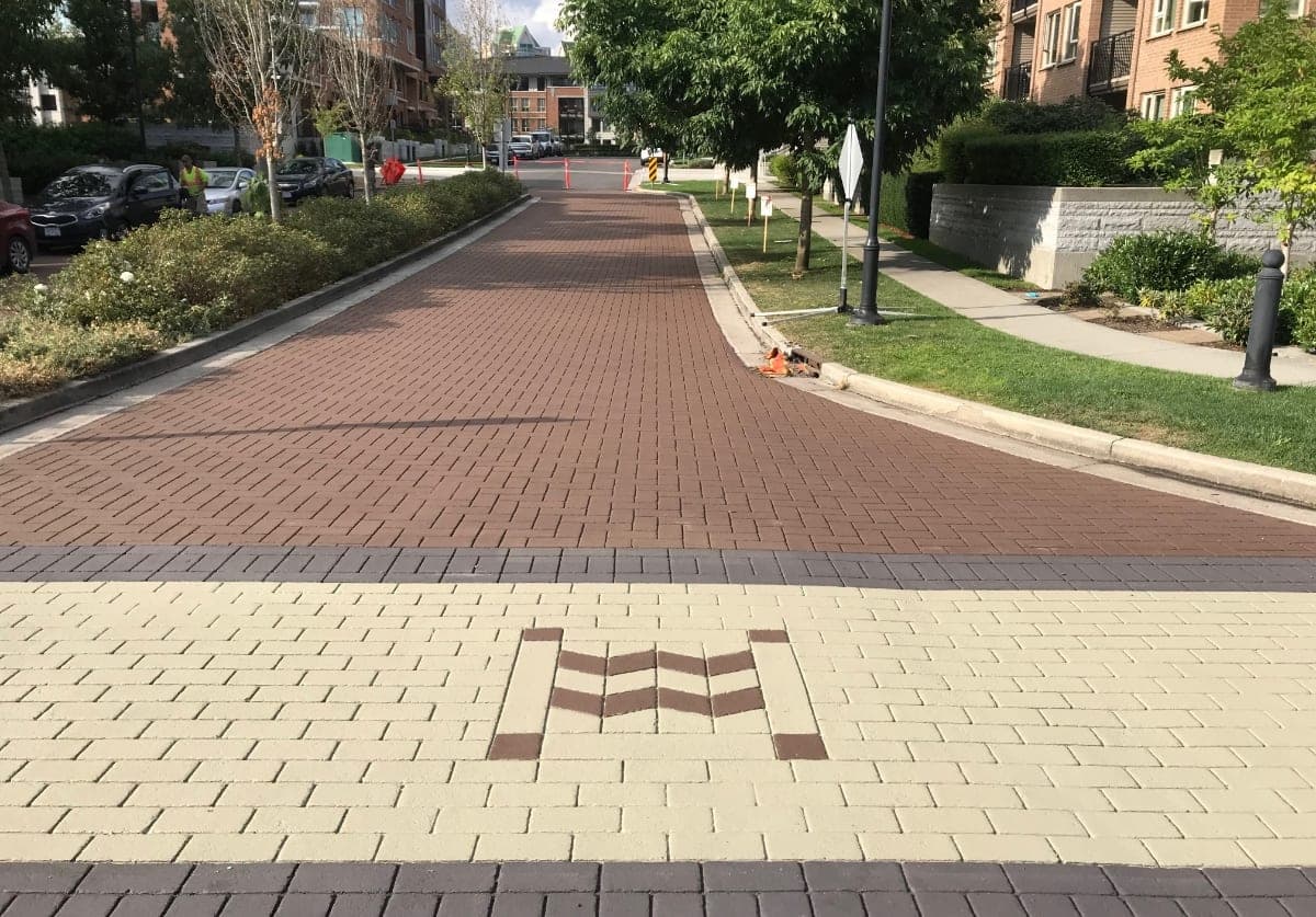 Public art pavement installation — DecoMark custom thermoplastic civic mural by HUB Surface Systems