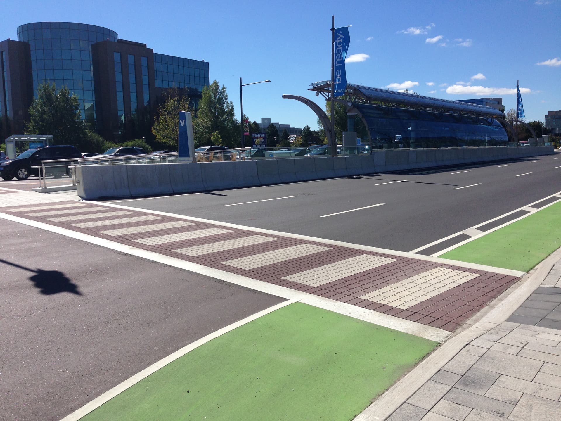 Decorative crosswalk specified for high-visibility pedestrian crossing — a signalized urban intersection