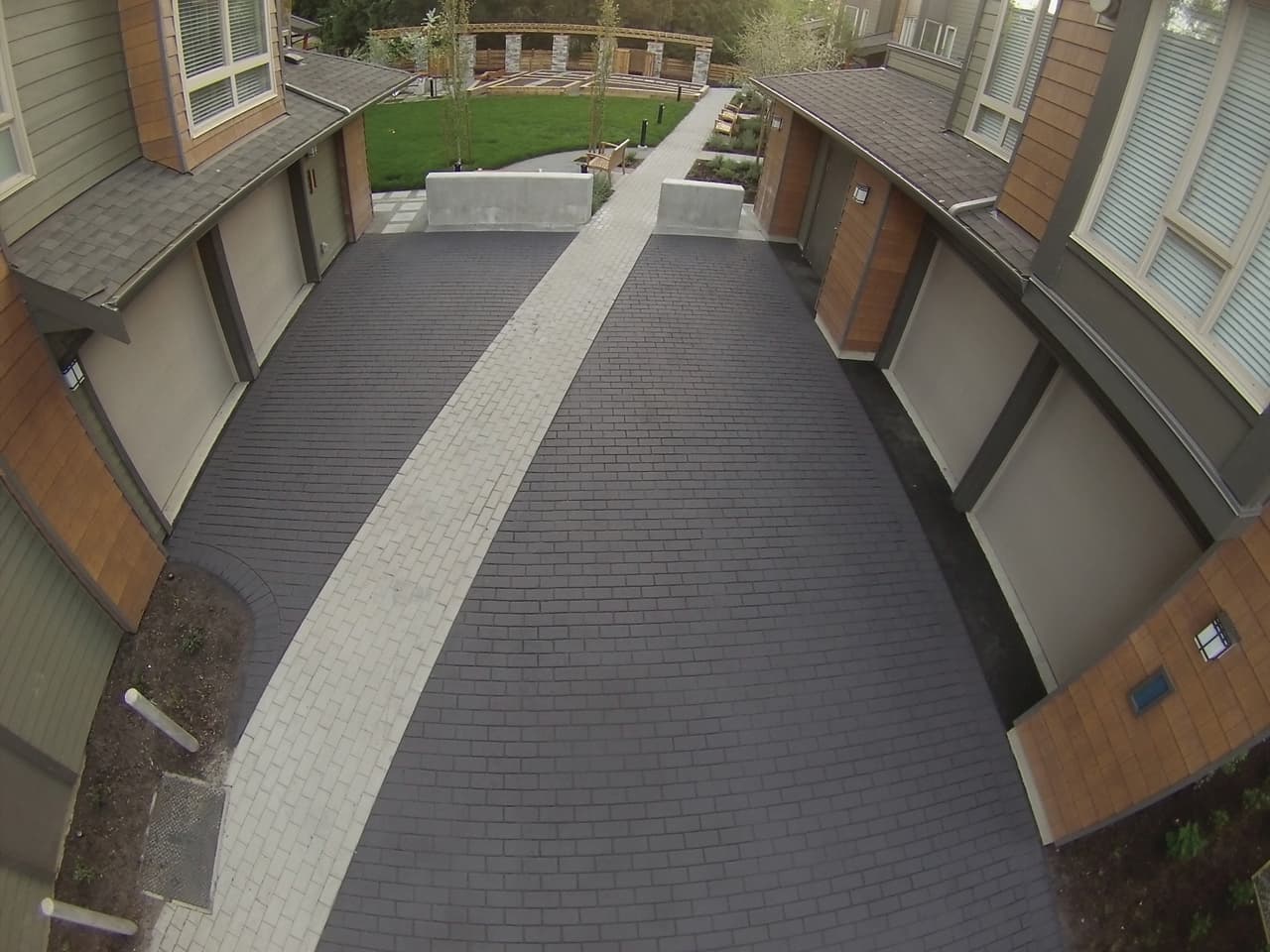 Townhome community paving in stamped asphalt and coloured pavement coating — a multi-family courtyard, Canada