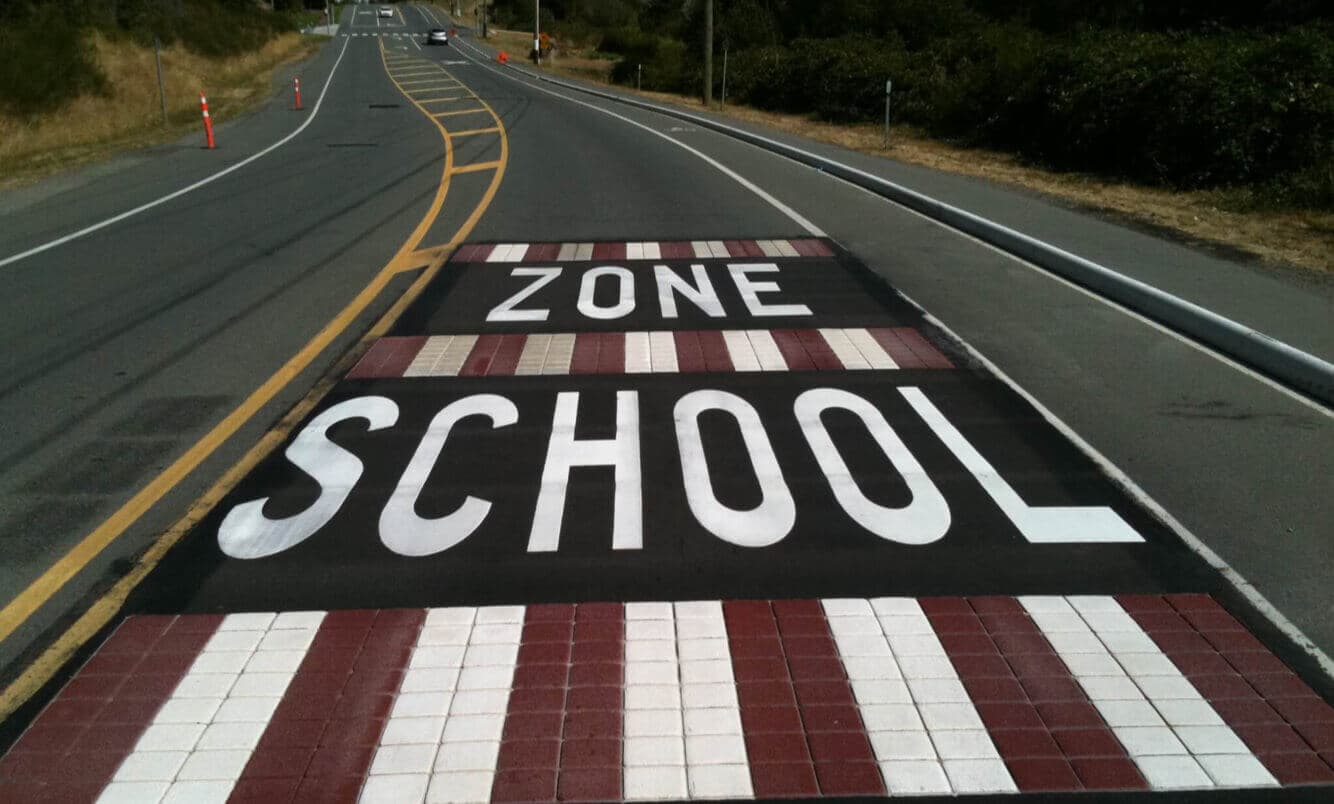 Traffic calming surface treatment specified for speed reduction and pedestrian priority — a village centre main street