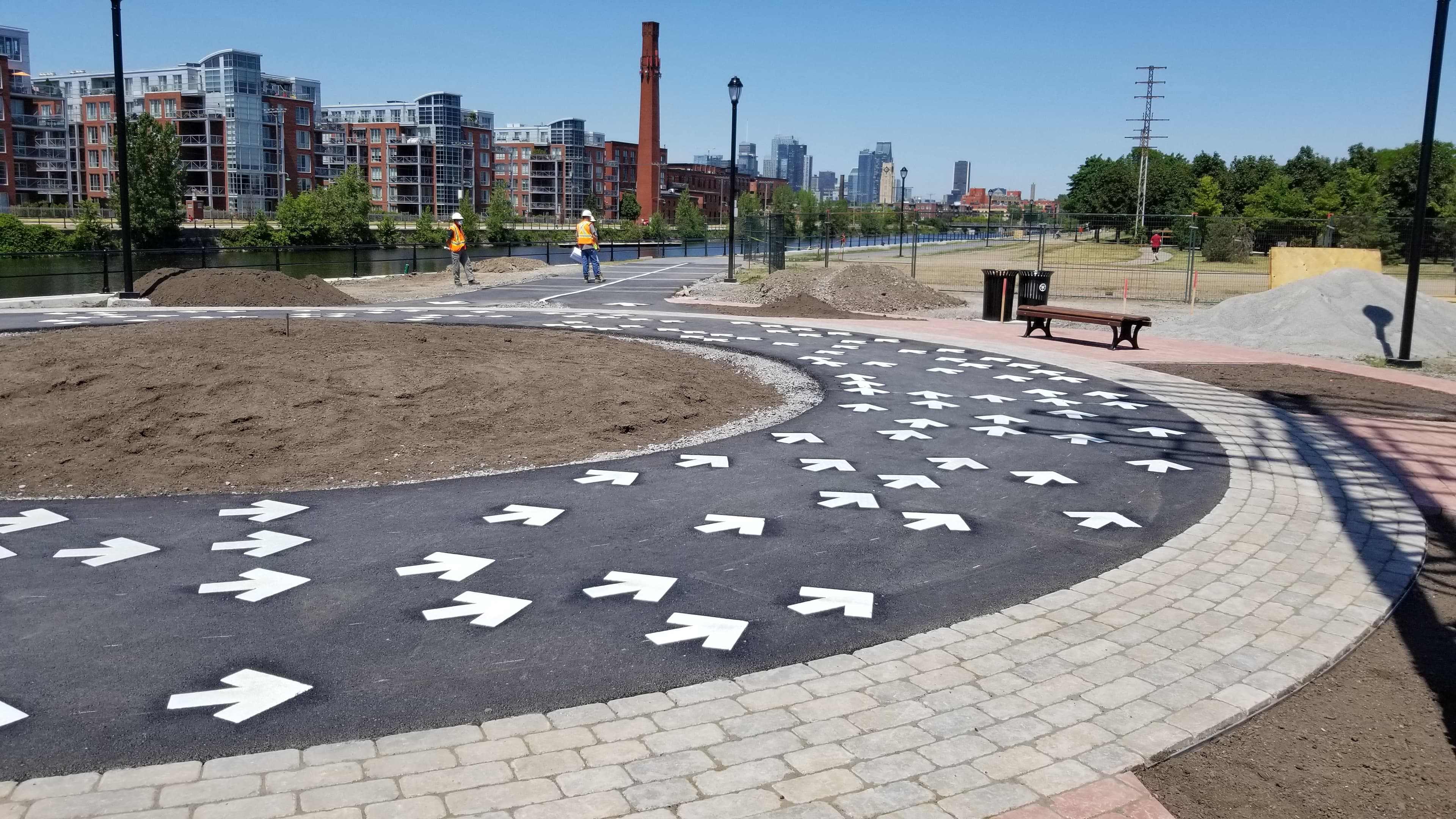 HUB Surface Systems DecoMark decorative pavement graphics — logos, art, and custom pavement design at a rainbow crosswalk