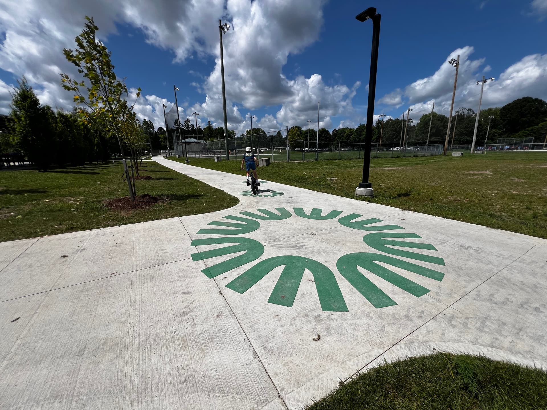 HUB Surface Systems DecoMark decorative pavement graphics — logos, art, and custom pavement design at a rainbow crosswalk