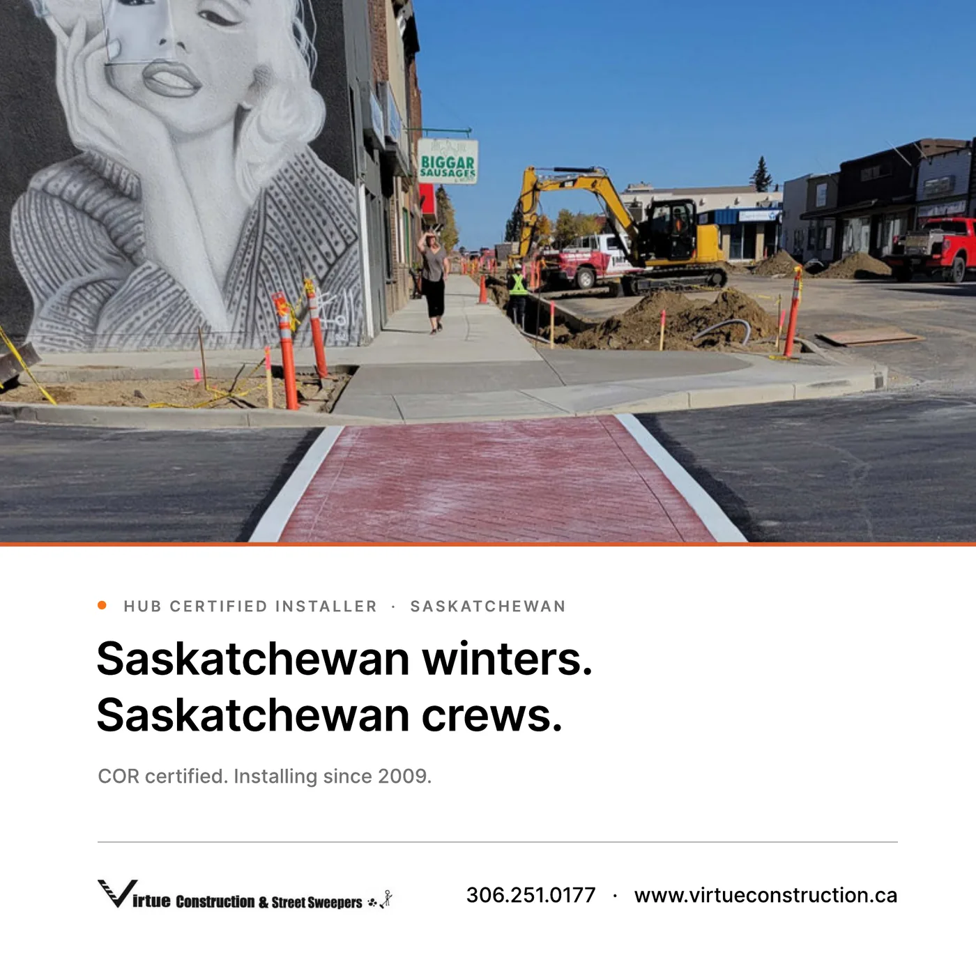 A red TrafficPatternsXD crosswalk being installed on a small-town main street