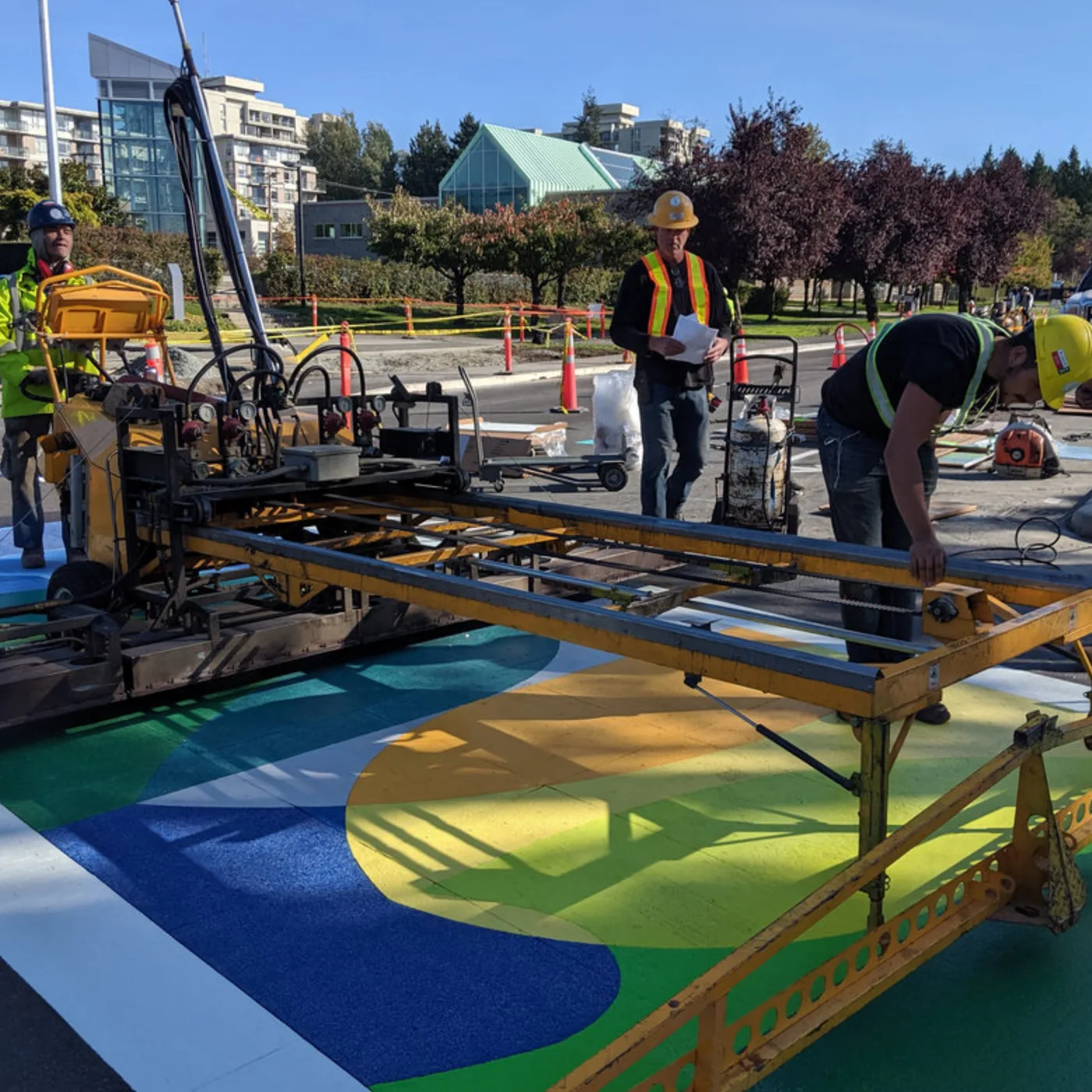 A HUB crew installing a blue and green StreetBond design