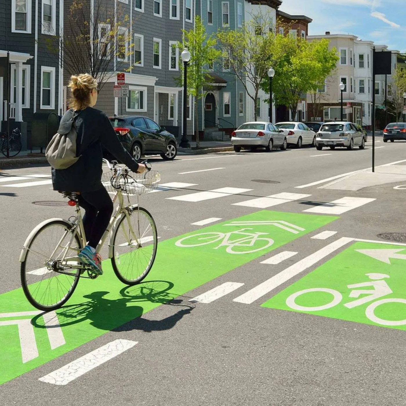 A cyclist on a green MMAX bike lane
