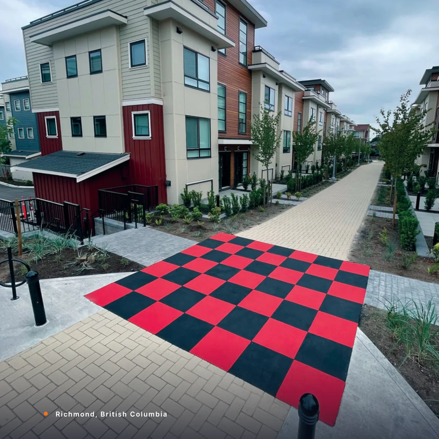 A red and black StreetBond checkerboard walkway at Parc Riviera, Richmond, British Columbia