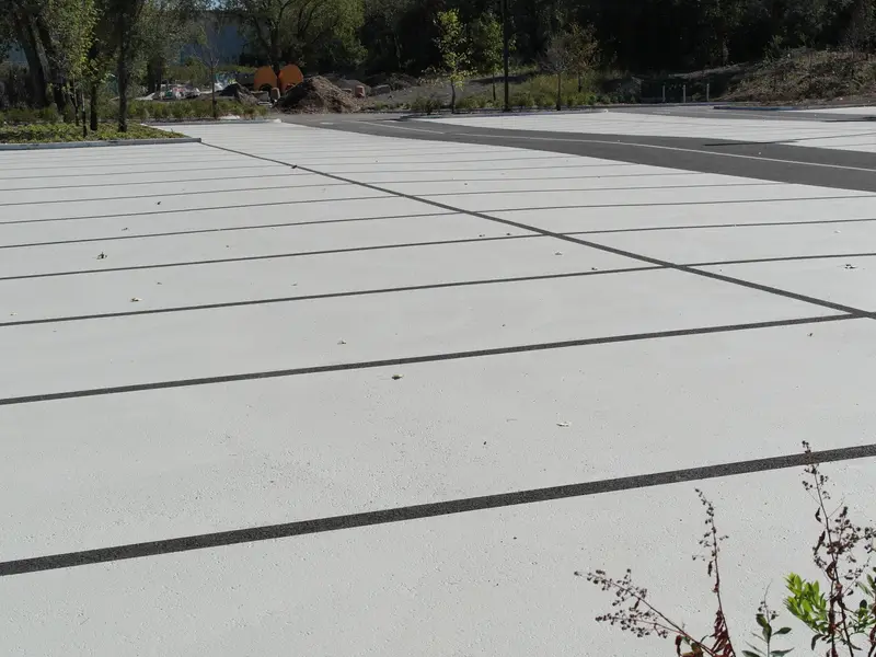 Pale grey StreetBondSR solar-reflective coating on a parking lot